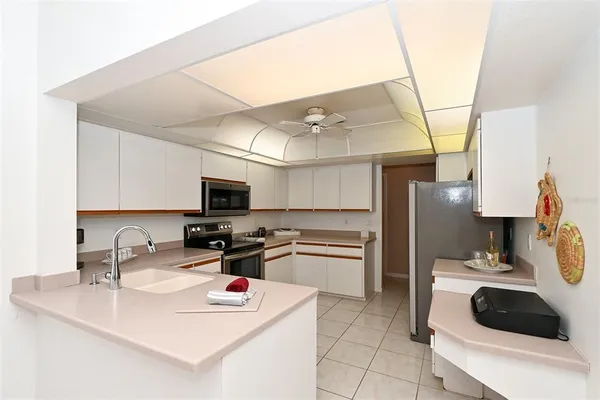 a kitchen with stainless steel appliances a refrigerator sink and microwave