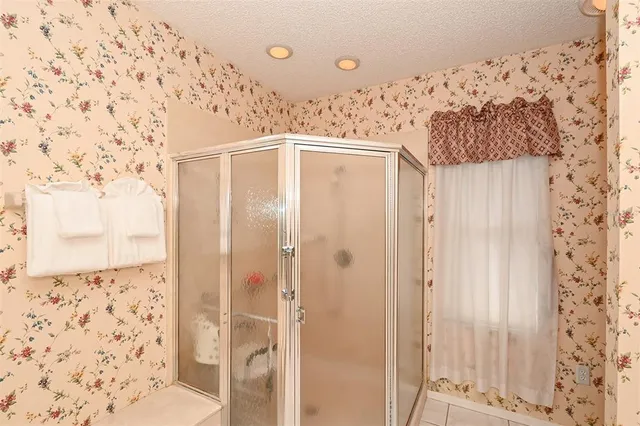 a bedroom with two beds and a chandelier