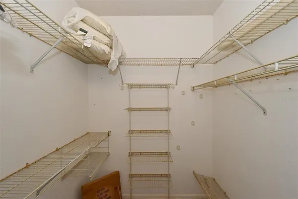 a bedroom with 2 bed and a chandelier