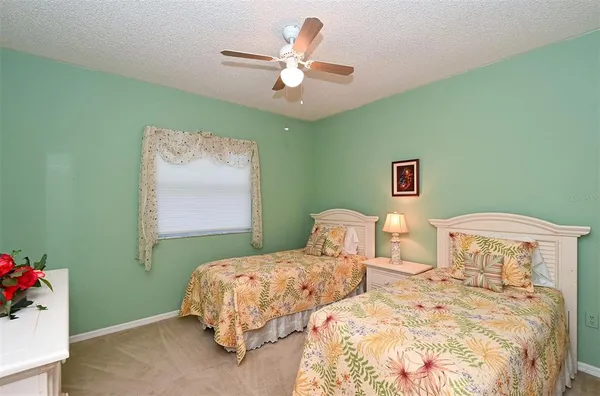 a bedroom with a bed and a ceiling fan