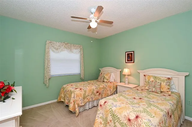 a bedroom with a bed and a ceiling fan
