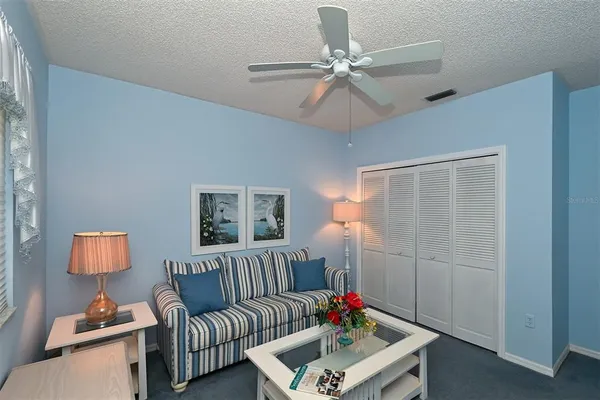 a living room with patio furniture and a yard