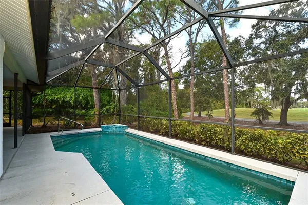 a swimming pool with outdoor seating and yard