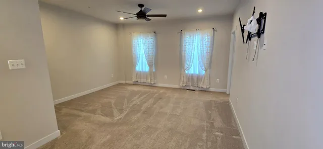 a view of empty room with ceiling fan