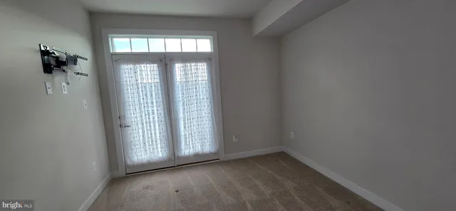 a view of room with hardwood floor and window