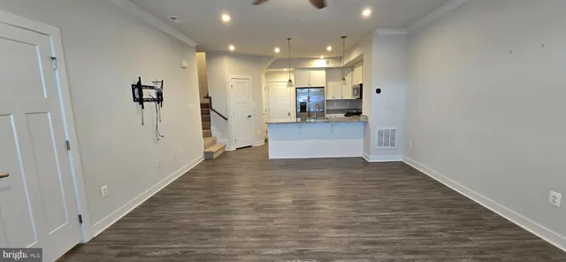 a view of kitchen with cabinets and wooden floor