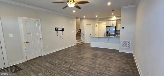a view of a kitchen with a sink and a refrigerator