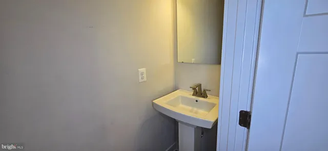 a bathroom with a sink and mirror