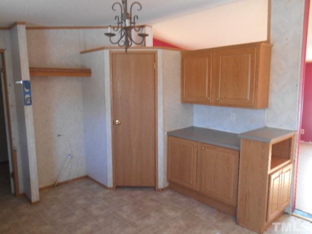 1251 Concord Ceffo Road Roxboro, NC 27574 - Photo 8 of 12 a view of a kitchen with cabinets and wooden floor