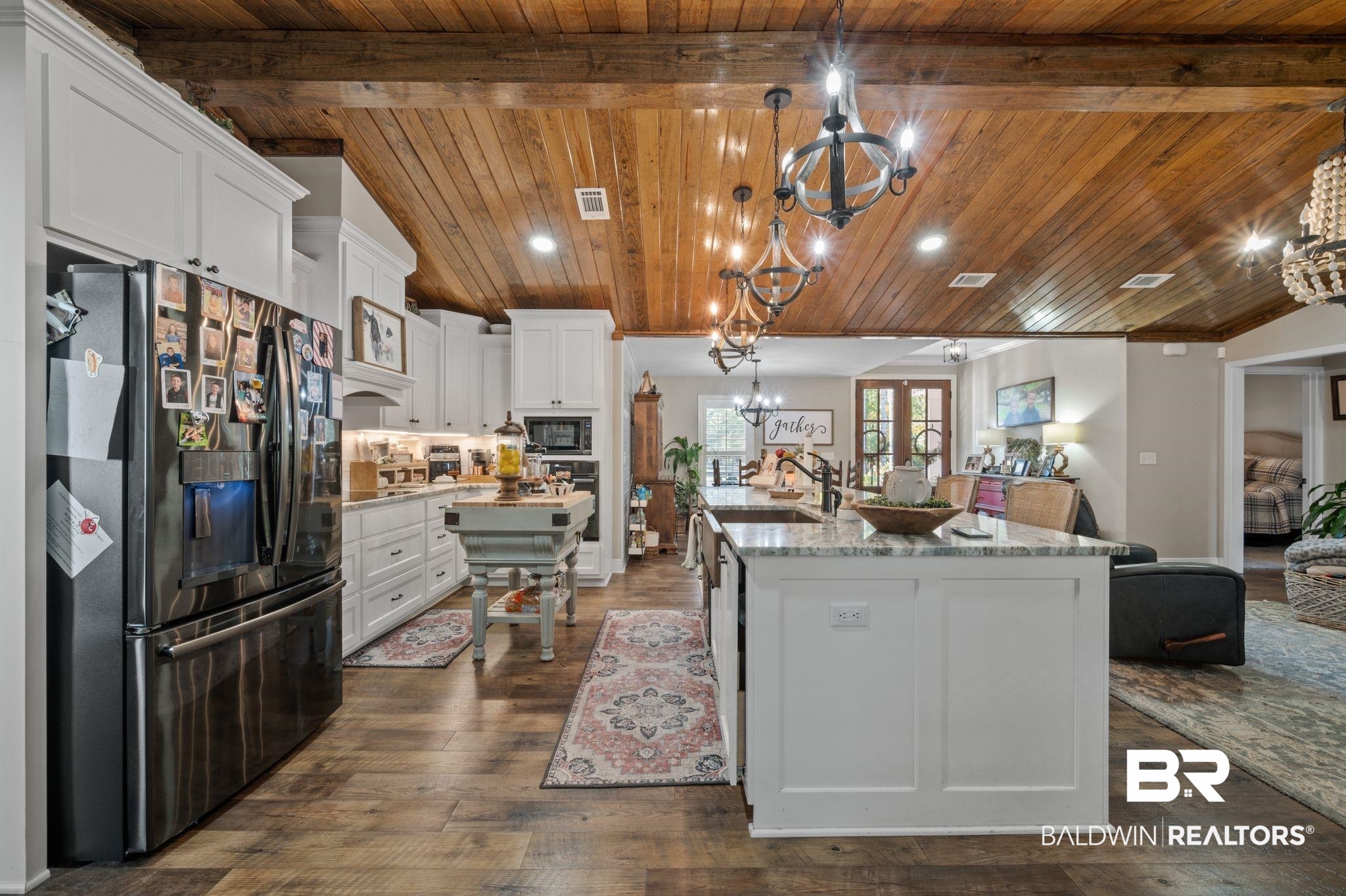 38211-d) V R Byrd Road Bay Minette, AL 36507 - Photo 8 of 58 Kitchen with stainless steel appliances, white cabinetry, a kitchen island with sink, and wood ceiling