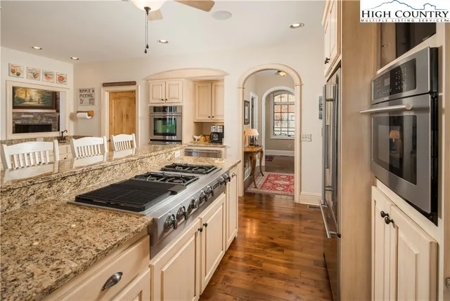 a kitchen with stainless steel appliances granite countertop a stove and a refrigerator