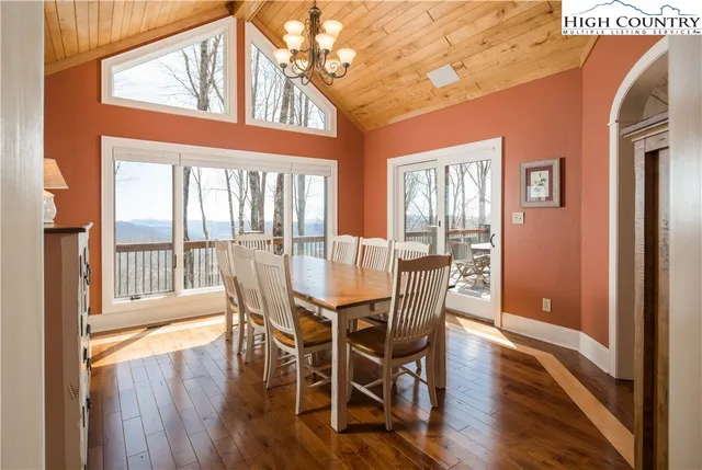 a view of a dining room with furniture wooden floor and a chandelier