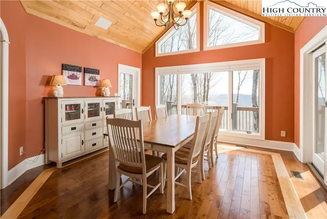 a view of a dining room with furniture wooden floor and a chandelier