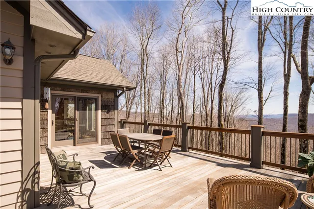 a view of a patio with a table chairs and wooden fence