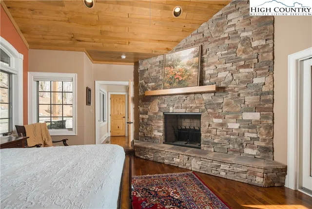 a spacious bedroom with a bed and a fireplace