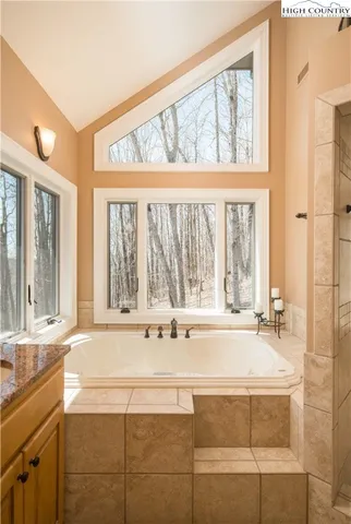 a view of a bathroom with a tub and a large window