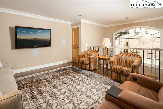 a living room with furniture tv and a window