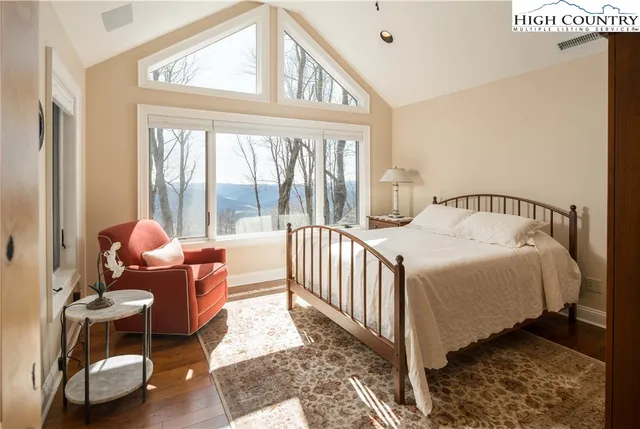 a bedroom with a bed and glass window