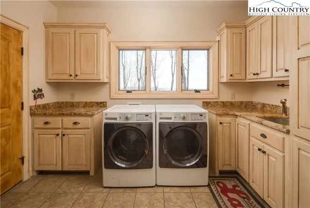 a utility room with sink dryer and washer