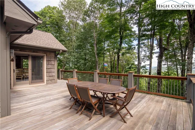 a view of a wooden deck with table and chairs