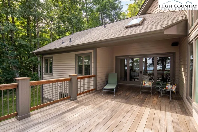 a view of a patio with table and chairs wooden floor and fence