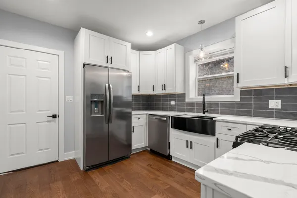 a view of a kitchen with a sink and cabinets