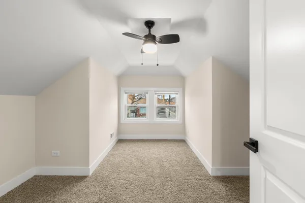 an empty room with a empty space and a ceiling fan