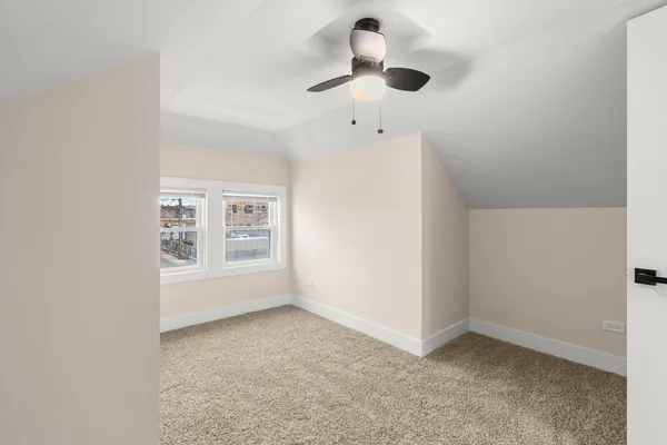 a view of a room with wooden floor and window