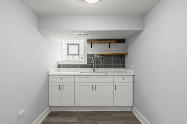 a bathroom with a toilet a sink a mirror and bathtub