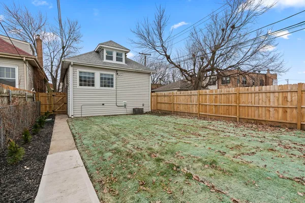 a view of a backyard with a fence