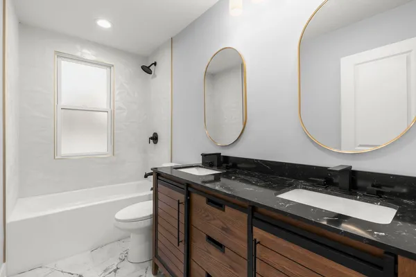 a bathroom with a sink a toilet and a mirror