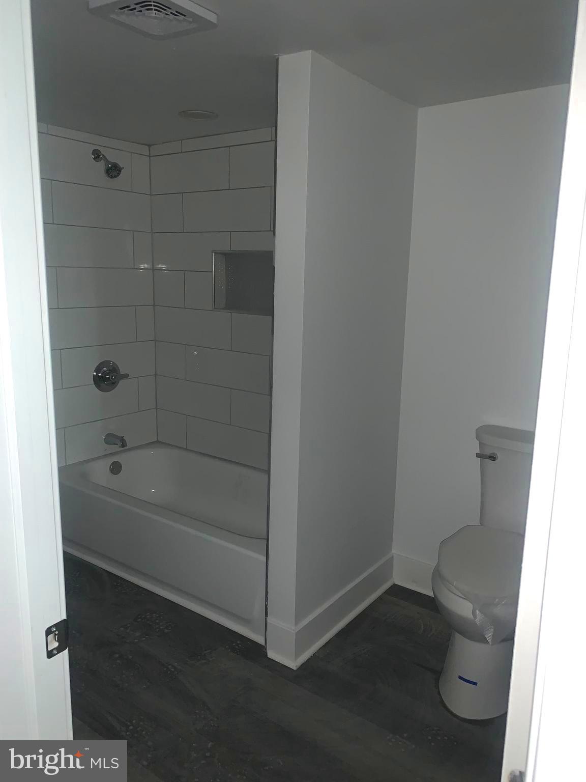 4906 Harford Road Baltimore, MD 21214 - Photo 26 of 31 a bathroom with a bathtub and a toilet