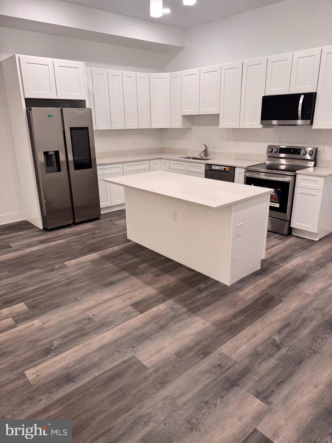 4906 Harford Road Baltimore, MD 21214 - Photo 27 of 31 a kitchen with granite countertop a refrigerator stove top oven and sink