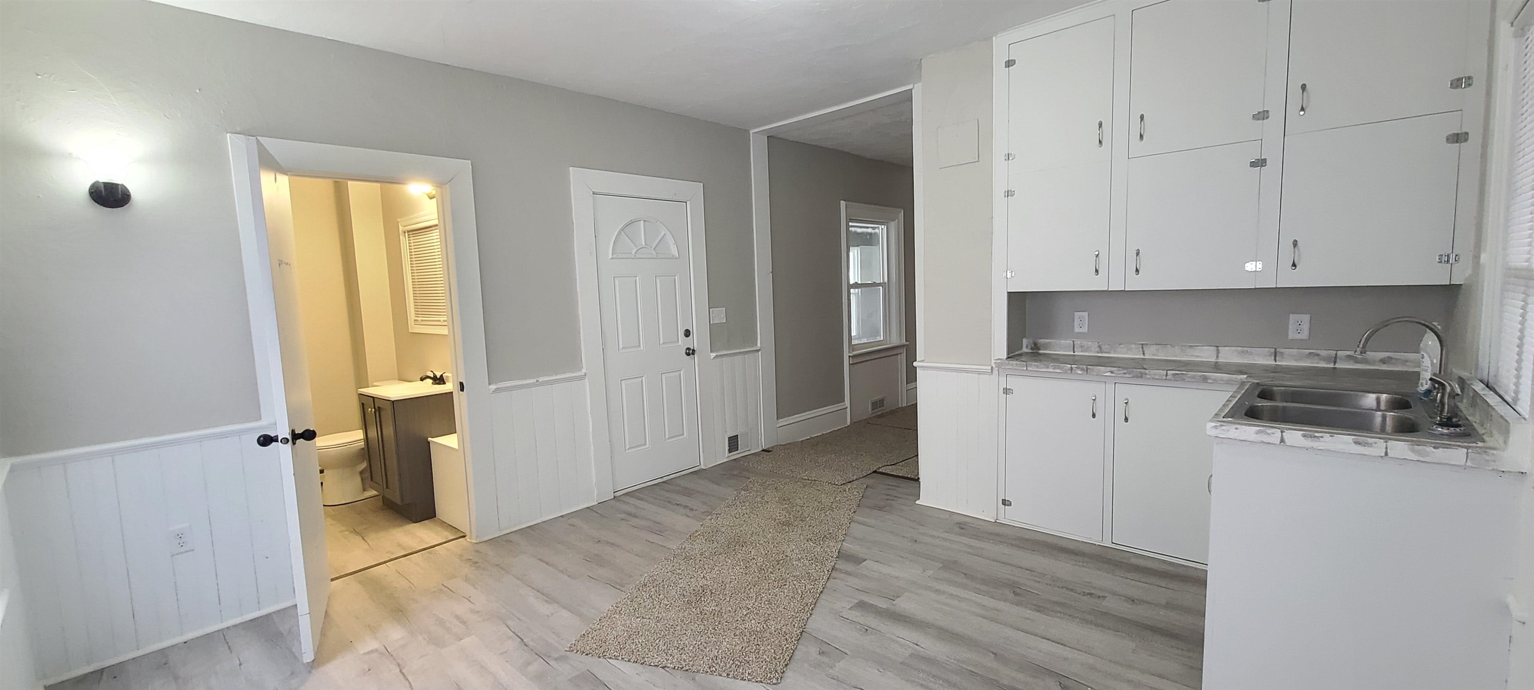 894 Bend Road Dixon, IL 61021 - Photo 8 of 23 a view of a kitchen with white cabinets and wooden floor