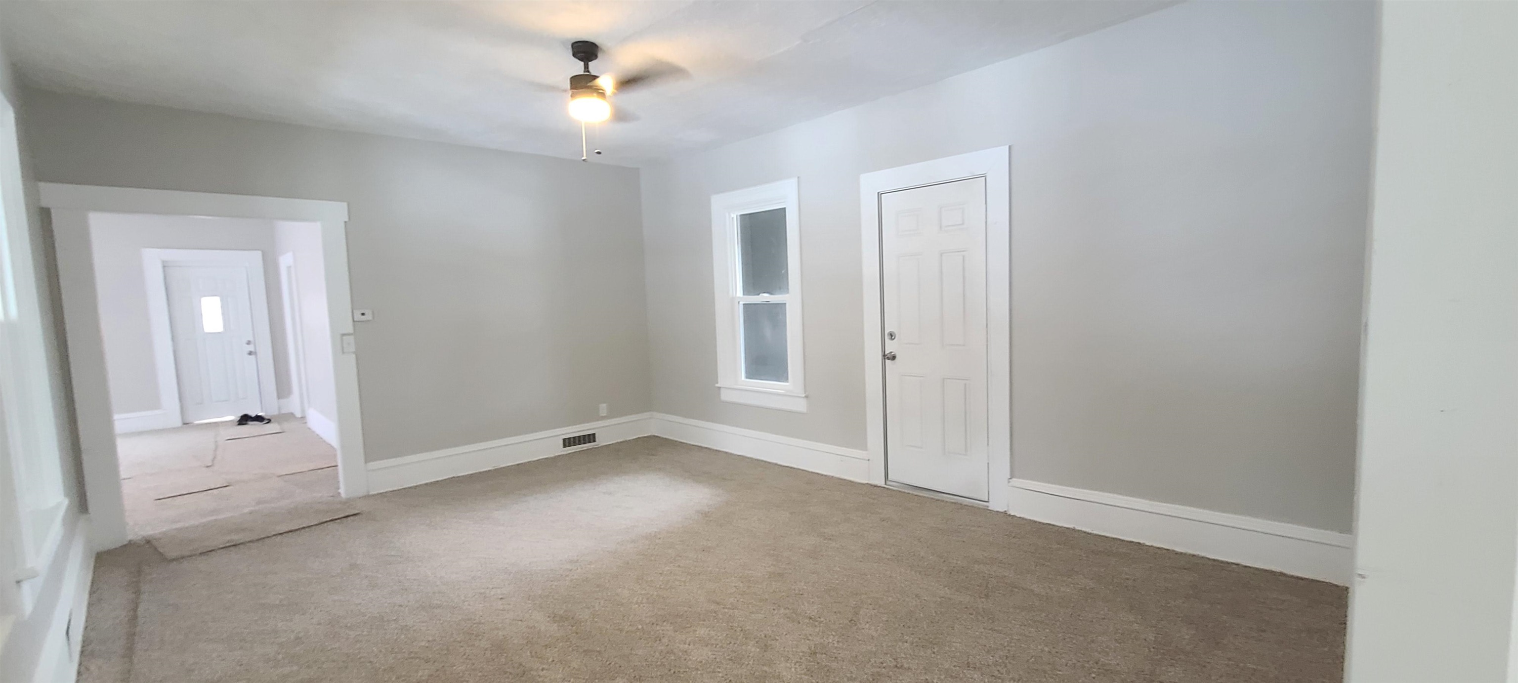894 Bend Road Dixon, IL 61021 - Photo 9 of 23 an empty room with chandelier fan and windows