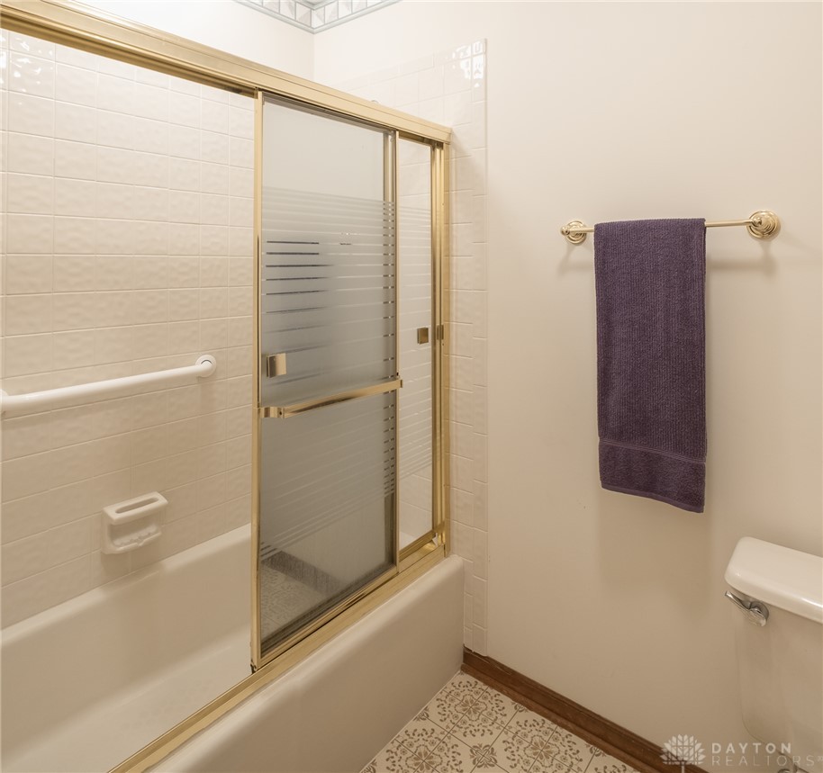 276 South Fairfield Road Bellbrook, OH 45305 - Photo 31 of 38 This bright bathroom features a combined shower and bathtub, complete with tiled walls and patterned flooring.