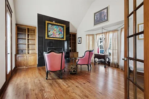 a living room with furniture and a floor to ceiling window