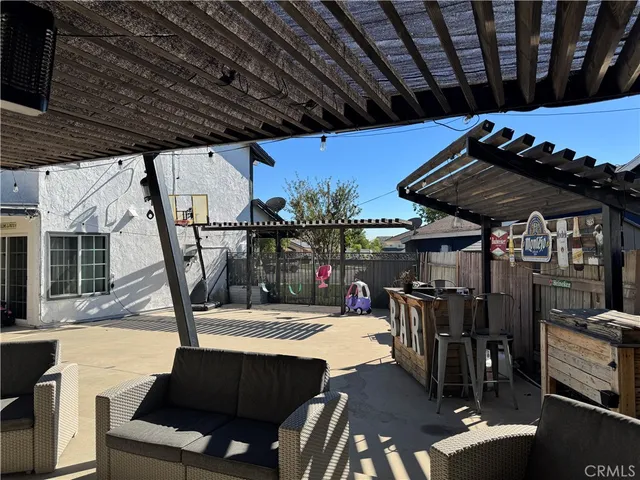 a view of a patio with table and chairs