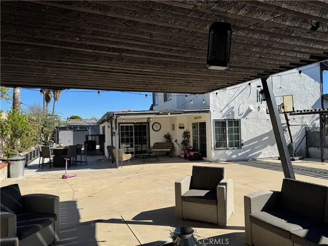 a view of a patio with a table and chairs under an umbrella