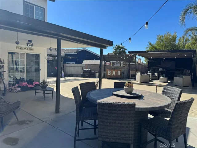 a view of a dining room with furniture and chandelier