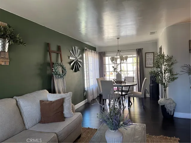 a living room with furniture dining table and a potted plant