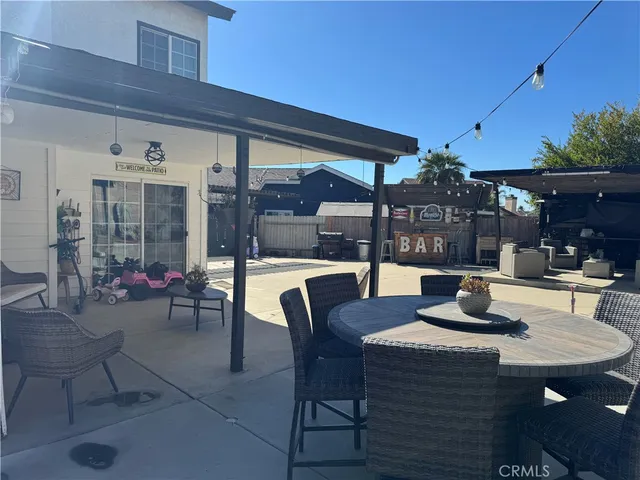 a dining area with a table and chairs