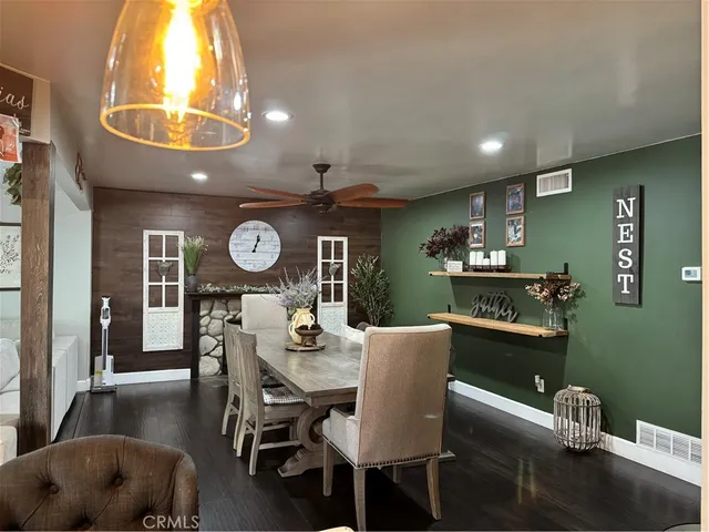 a view of a dining room with furniture and chandelier