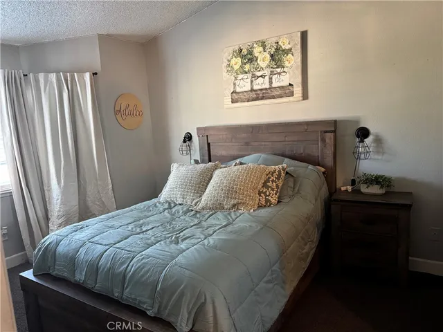 a bed sitting in a bedroom next to a window