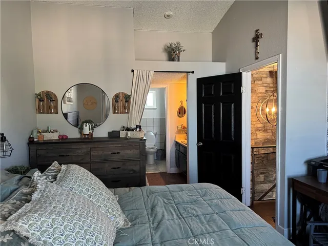 a bed room with a bed and a dresser