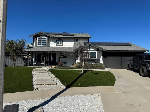 a front view of a house with a yard table and chairs
