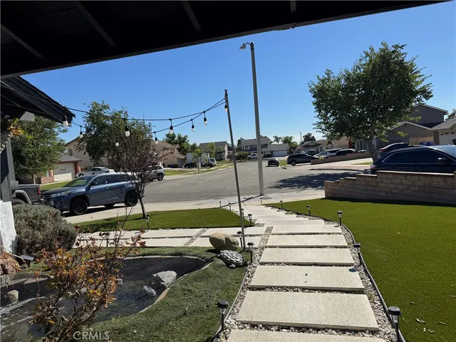 a view of a backyard with lawn chairs