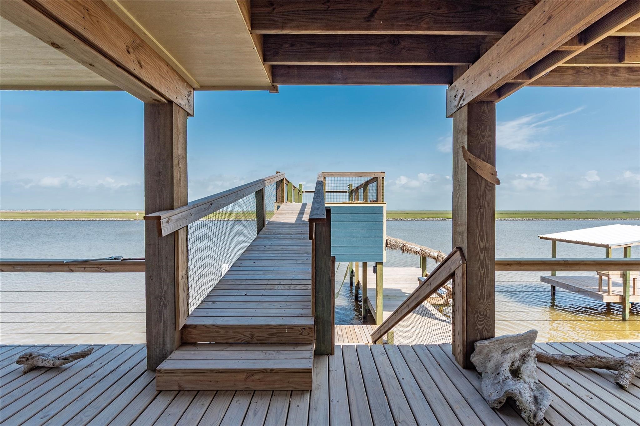 1453 County Road 230 Sargent, TX 77414 - Photo 26 of 38 Experience serene waterfront living with a stunning 2-tier walk-up deck offering breathtaking views of ICW and the beach.