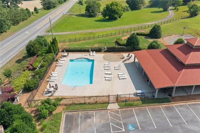 an aerial view of a house with a yard basket ball court and outdoor seating
