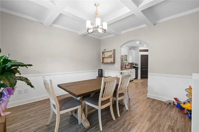 a view of a dining room with furniture and wooden floor